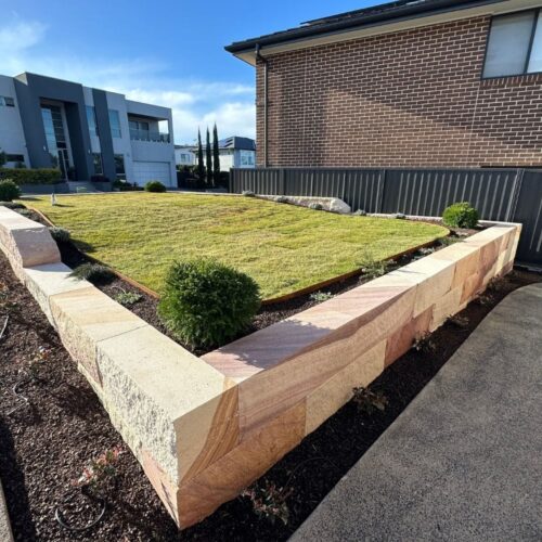 front yard landscaping with retaining wall and lawn
