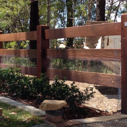 wooden fence with wire mesh and landscaping